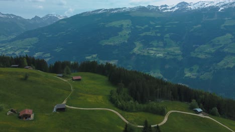 aerial drone at scenic zillertal skiing sport hiking and trekking vacation mountain valley along cottages, lodges and trees in nature in the austrian bavarian alps on a sunny lush summer day