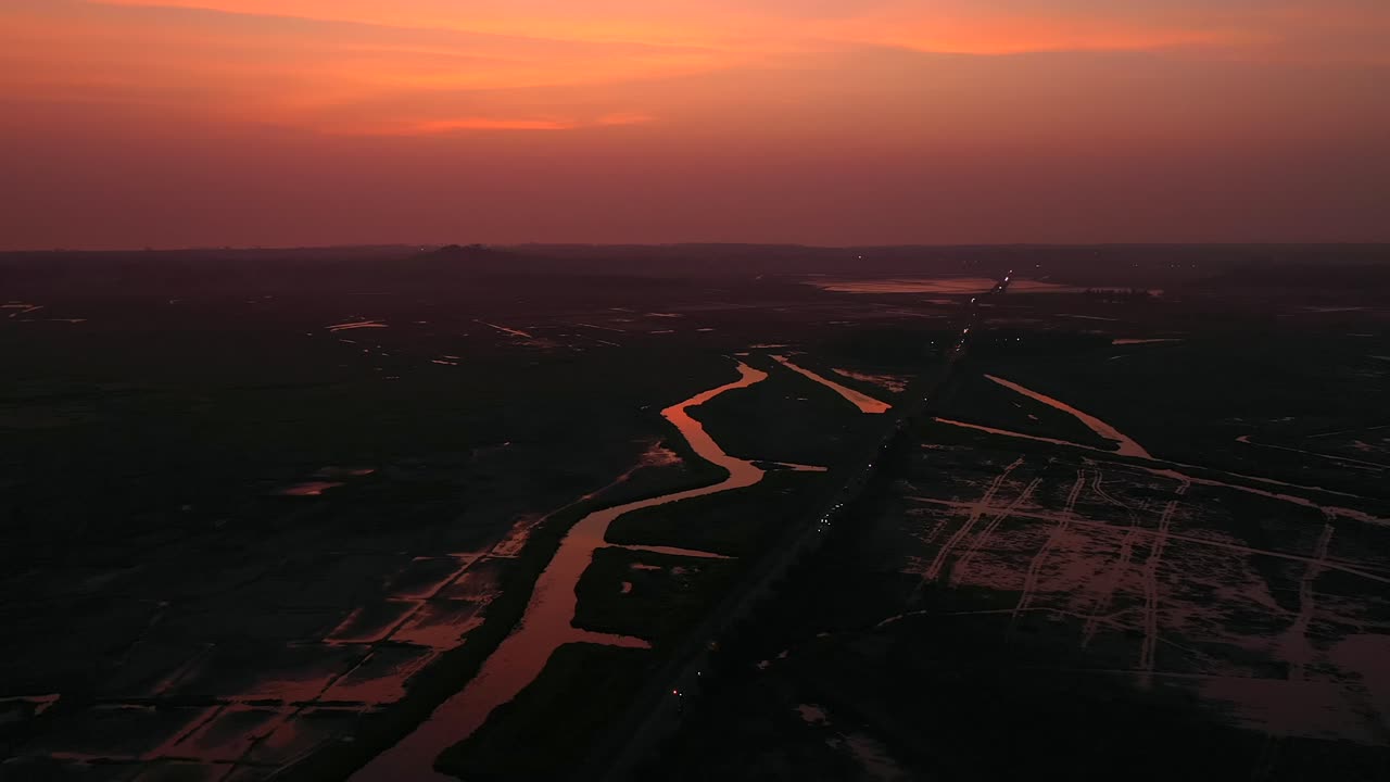 cielo rojo al anochecer sobre el arroyo en vasai, mumbai, india