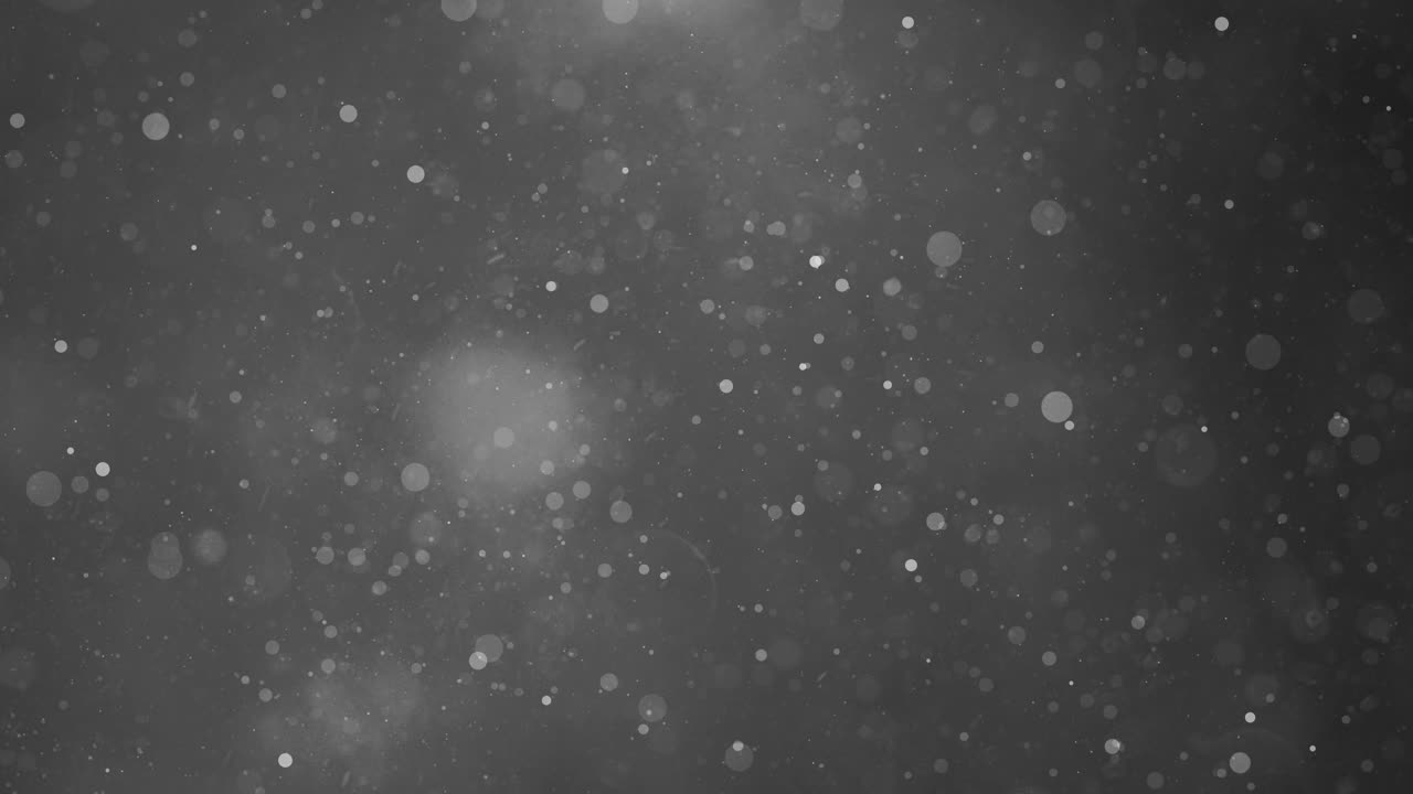 An abstract black and white background featuring bokeh lights and particles, creating a dreamy and ethereal atmosphere