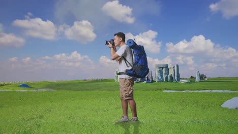 Photographer in a field with a backpack