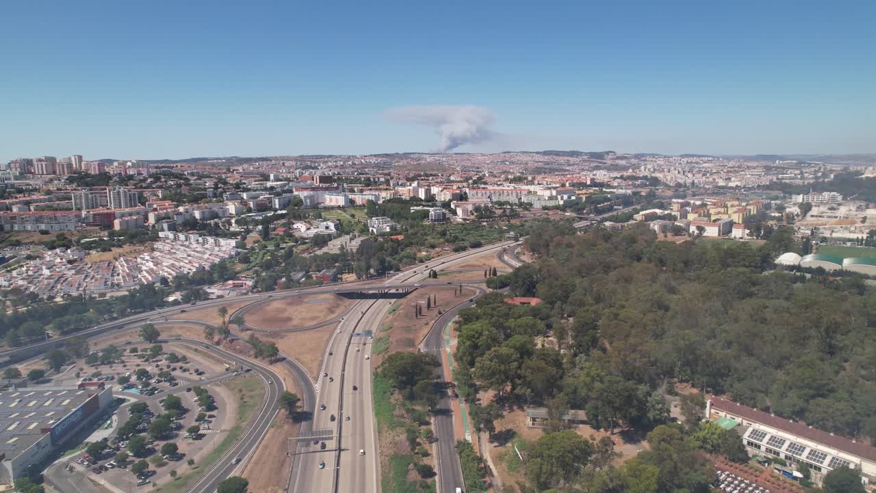 Drone pan shot of the Lisbon City Fire event from a distance. Highway traffic in Portugal