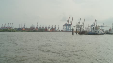 Little-Ferry-Passes-Through-Elbe-River-And-Harbour-Of-Hamburg-On-Grey-Day,-Germany