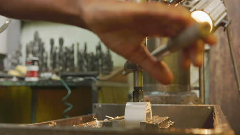 Caucasian-male-hands-factory-worker-at-a-factory-standing-at-a-workbench-and-operating-machinery