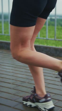 a dynamic sequence of feet in motion: capturing the essence of running as the finale of a video journey on a scenic pathway