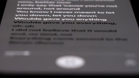 Highlighted-Lyrics-From-Song-Scrolling-On-Mobile-Phone,-Close-Up-Macro-Shot