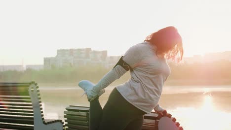 woman stretching her legs before running