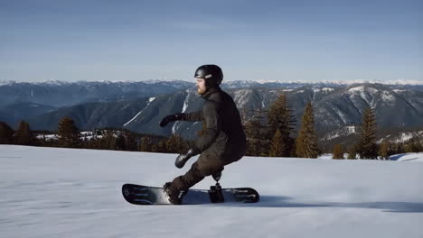 Snowboarder with prosthetic leg snowboarding in the mountains