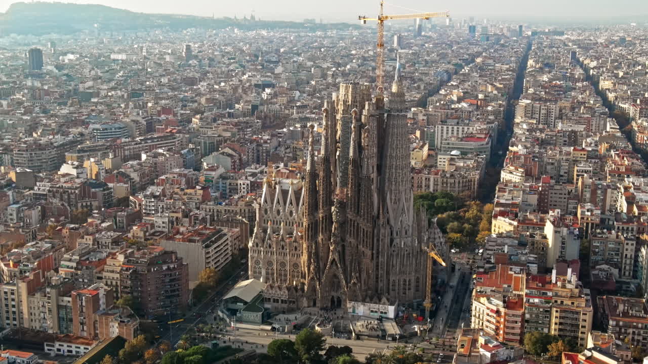Aerial drone view of Barcelona, Spain. Blocks with multiple residential buildings and Sagrada Familia