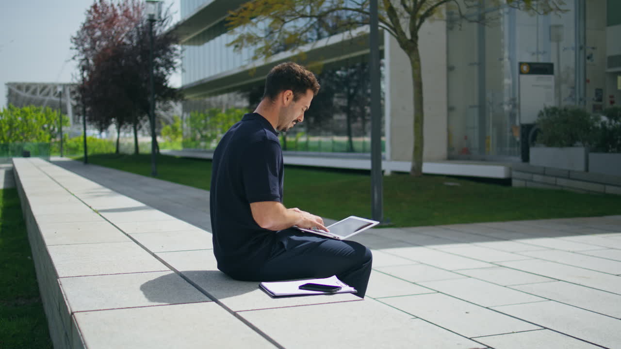 Freelancer man sitting bench street.  businessman texting laptop working