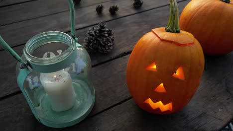 lantern and pumpkin carved jack-o-lantern shine their candle light