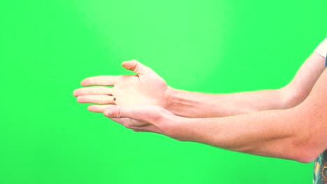 closeup view of male hand showing rock paper scissors on chromakey