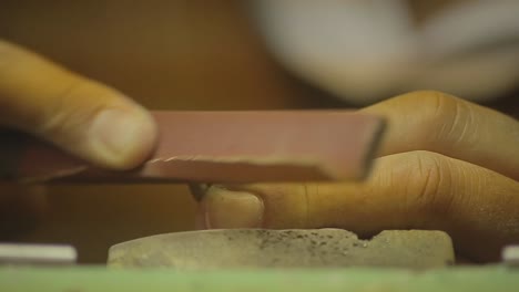 italian goldsmith at work building an engagement or a wedding ring