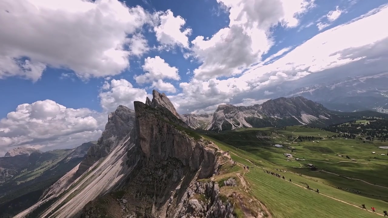 Fast cinematic FPV drone flight climbing toward the towering peaks of Seceda Ridge in the Italian Dolomites.