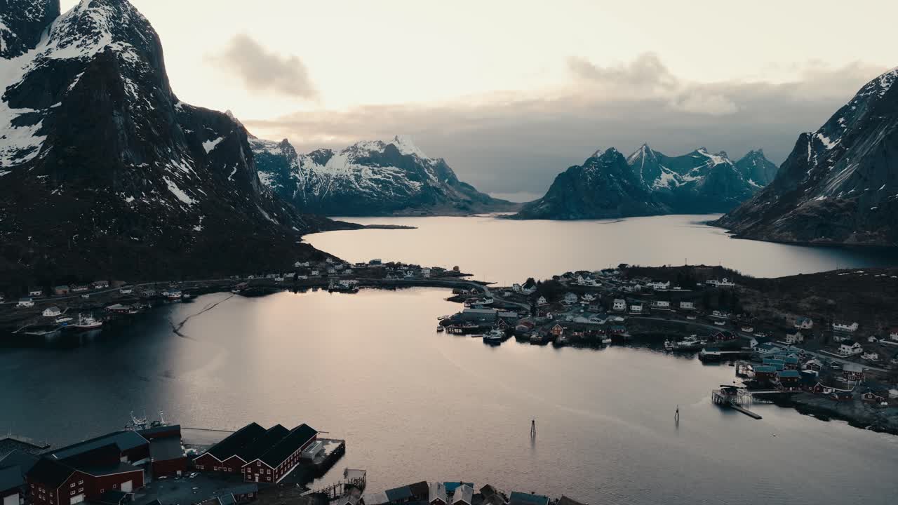 Dramatic Evening Sky Over Picturesque Village Of Reine In Norway's Lofoten Islands. aerial ascending shot