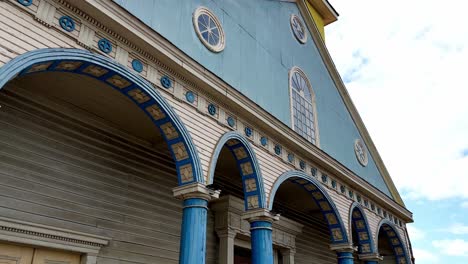 Panning-Up-View-Of-Blue-And-Yellow-Church-Of-Our-Lady-Of-The-Rosary,-Chonchi-Chile-Island