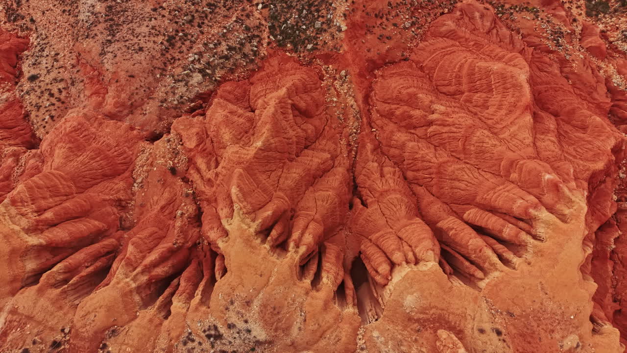 Le pareti del canyon mostrano strati di roccia e texture sotto la luce solare intensa a mezzogiorno in un paesaggio desertico.