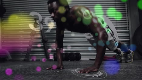 animation of light spots over african american man exercising at gym