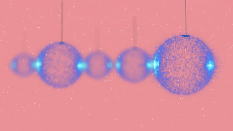 animación de bolas de navidad sobre la nieve que cae sobre un fondo rosa
