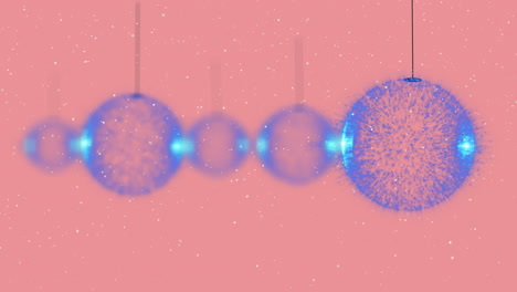 animation of christmas baubles over snow falling on pink background