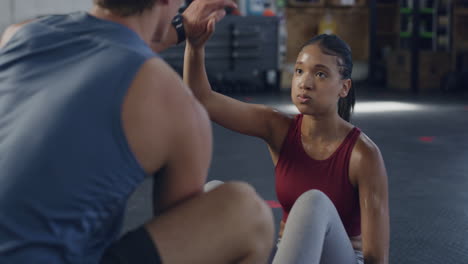 motivated female exercising with her personal