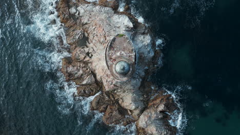 aerial view of a lighthouse on a rocky island