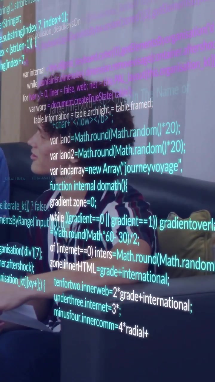Vertical video: Man with curly hair shifting on sofa during demo with code overlay covering face