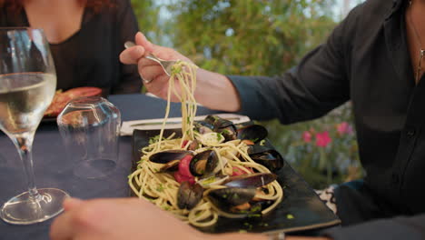 fork grabbing spaghetti with seafood during lunch at the beach restaurant