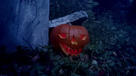 carved halloween pumpkin, flashing lights and waving leaves on branch, horror atmosphere of autumn tradition