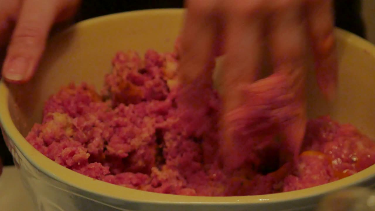 Mixing mince meat in a bowl
