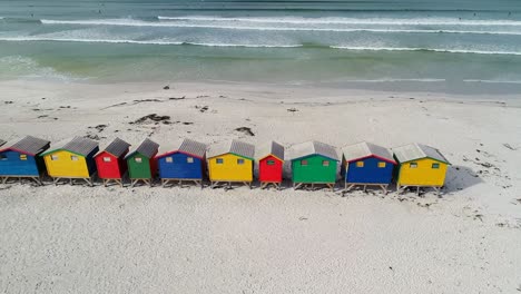 row of multicolored beach huts on the beach 4k