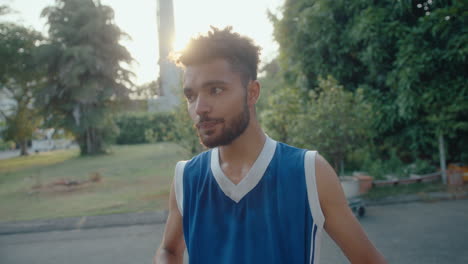 young basketball player having water break on outdoor court