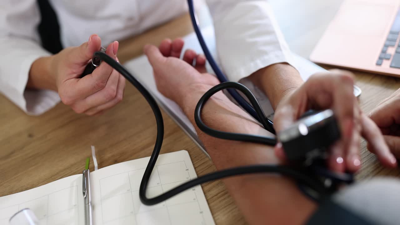 Medical professional measuring patient's blood pressure