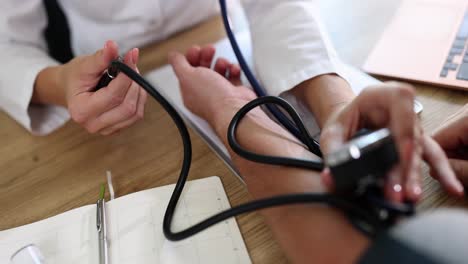medical professional measuring patient's blood pressure