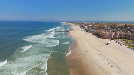 waves coming to the sandy shore of imperial beach with beachfront hotels in california, usa