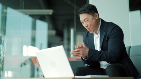 amazed asian male professional winner feeling happy receiving new job opportunity, reward bonus, celebrates financial market growth