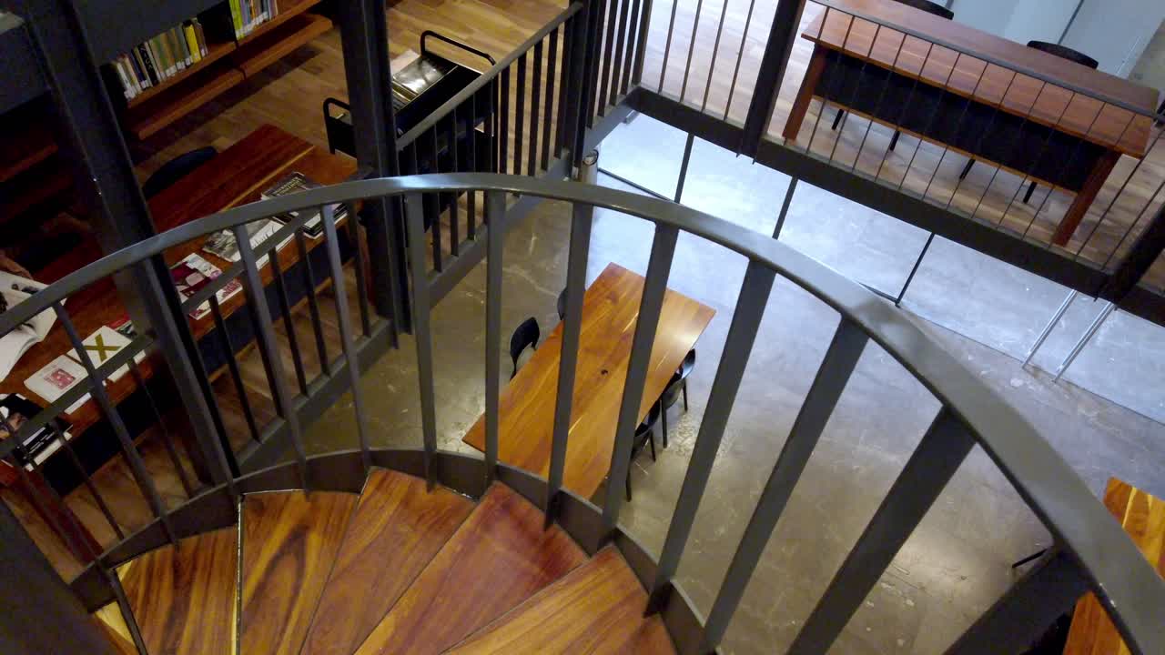 Wide shot of spiral staircase with wooden steps and metal railings inside the Modern Art Museum Cuernavaca