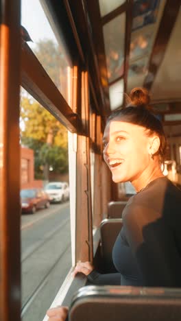a woman looks out the window of a tram