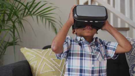 african american boy wearing vr headset and having fun