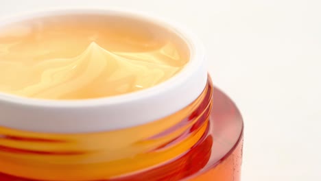 close-up of orange face cream jar