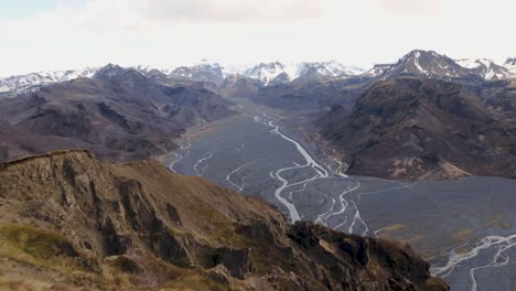 man standing on top of mountain looking at the view