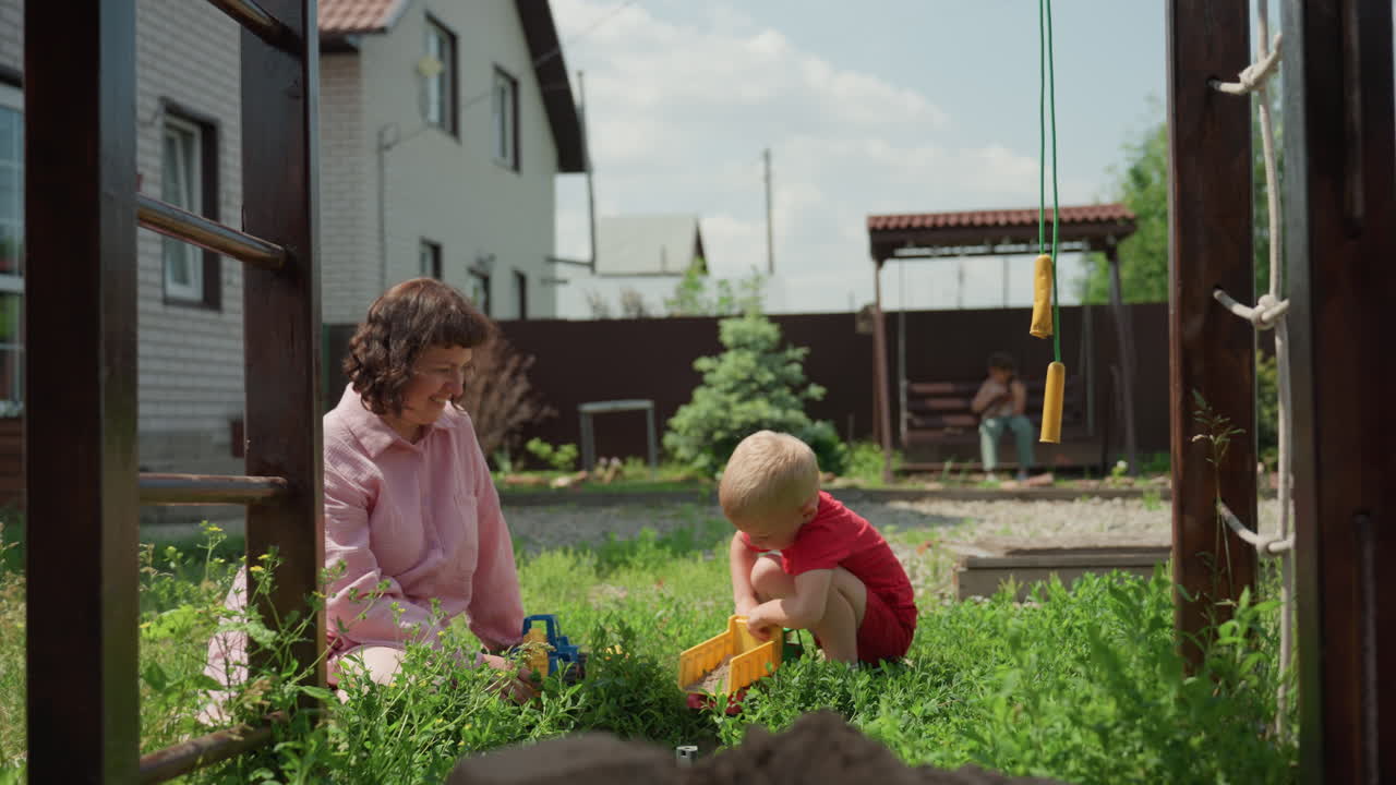 Child Playing Outside, Bright Backyard Toy Exploration Fun, Young Girl And Toddler Enjoying Backyard Playtime Together, Young Girl And Her Toddler Explore Toys In Sunny Suburban Yard
