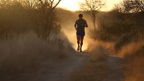 runner on a dirt road at sunrise
