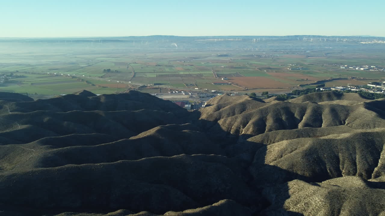 Aerial View of a Valley with Hills and Farmland