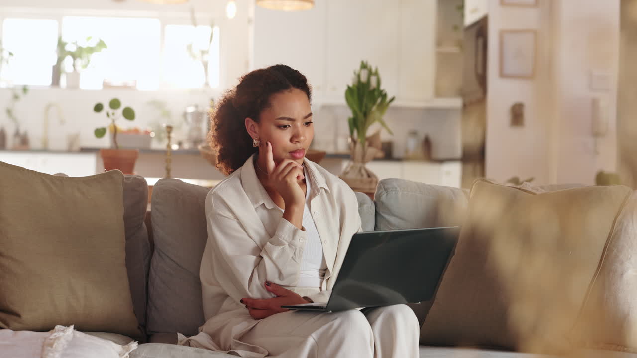 Woman Working on Laptop at Home