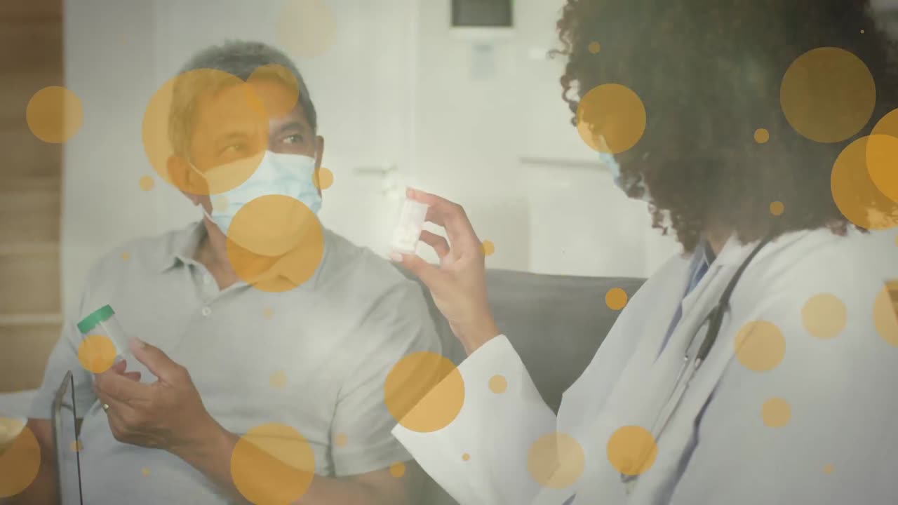 Animation of yellow spots over diverse female doctor and male patient with face masks on