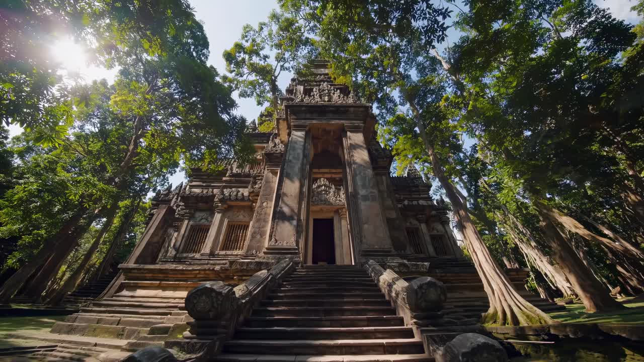 Low-angle video shot of an ancient temple surrounded by lush trees, capturing the grandeur