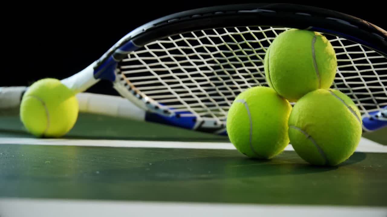 Close-up racket arranged on tennis balls 4k