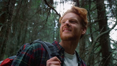 man standing in green forest