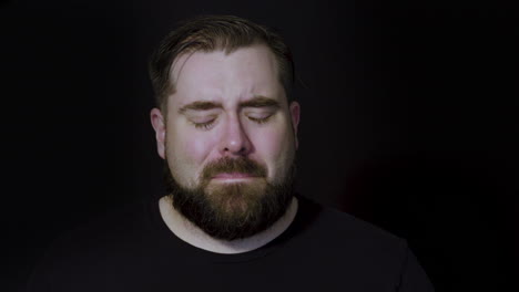 motion studio portrait of a man becoming upset after receiving bad news