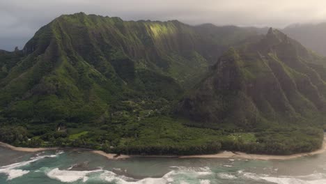 epic aerial above hawaii coast landscape of haena park, panoramic views on na pali coast park with green jungle mountain peaks covered by rain clouds